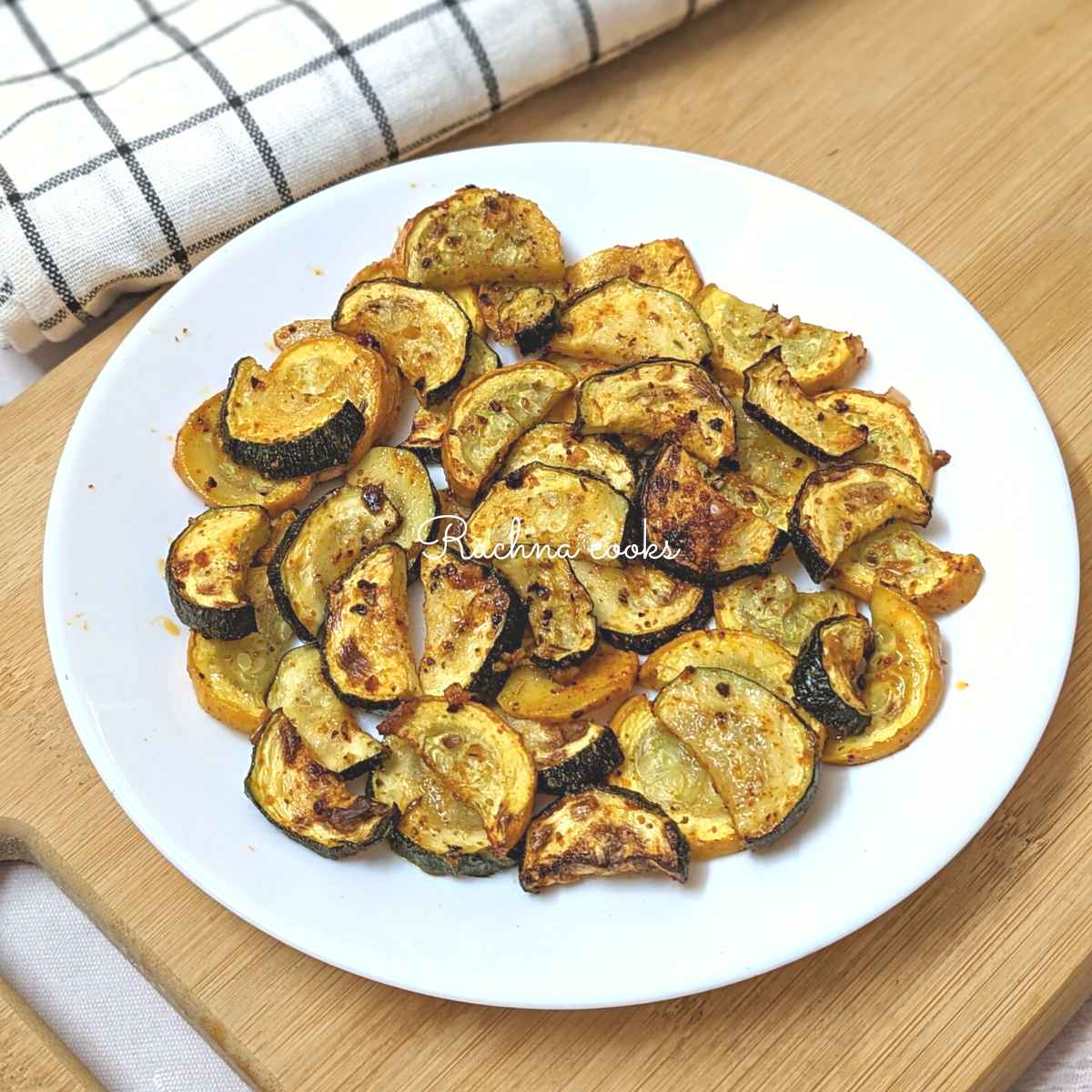 Air fried zucchini and squash slices served on a white plate.