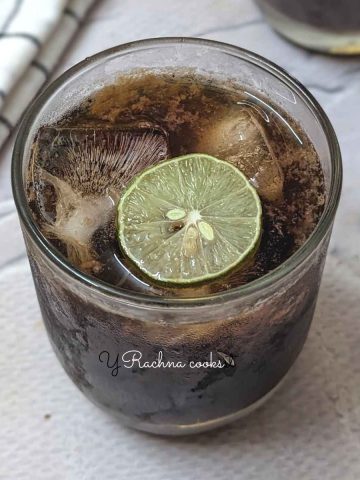 A glass of brown sugar lemonade with a lemon wedge