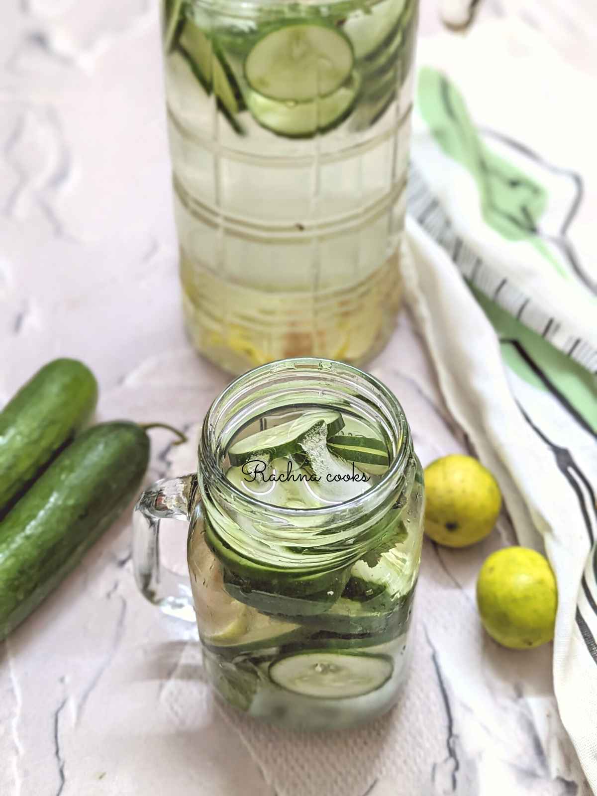 In foucs cucumber lemon ginger water served in a mason jar.