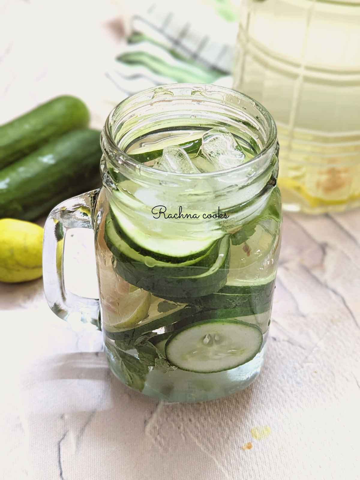In focus cucumber lemon ginger water served in a mason jar.