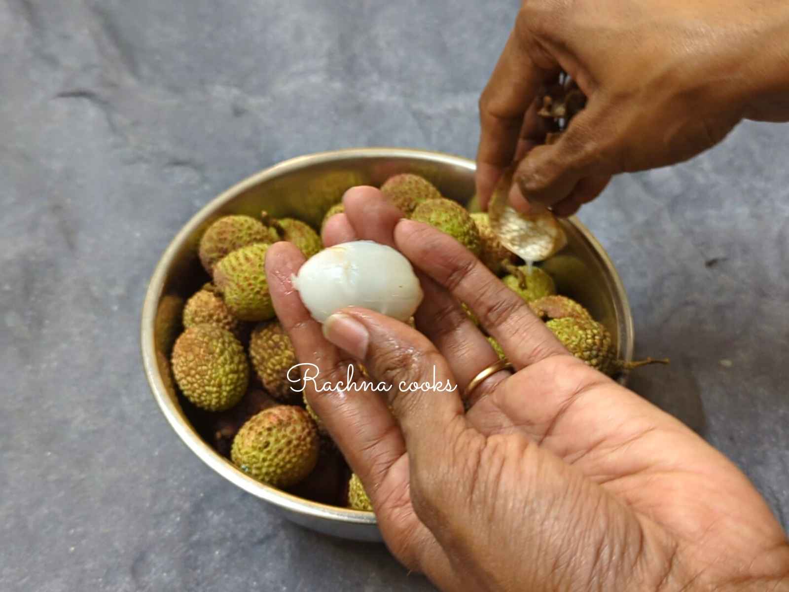 One lychee with flesh revealed after peeling off the skin.
