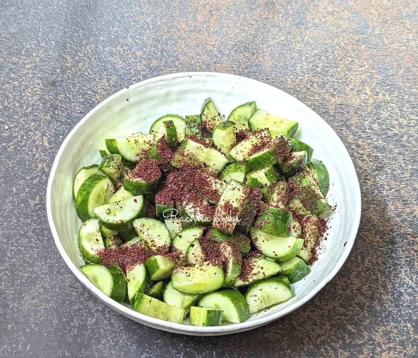 Sumac on chopped cucumbers with spices.