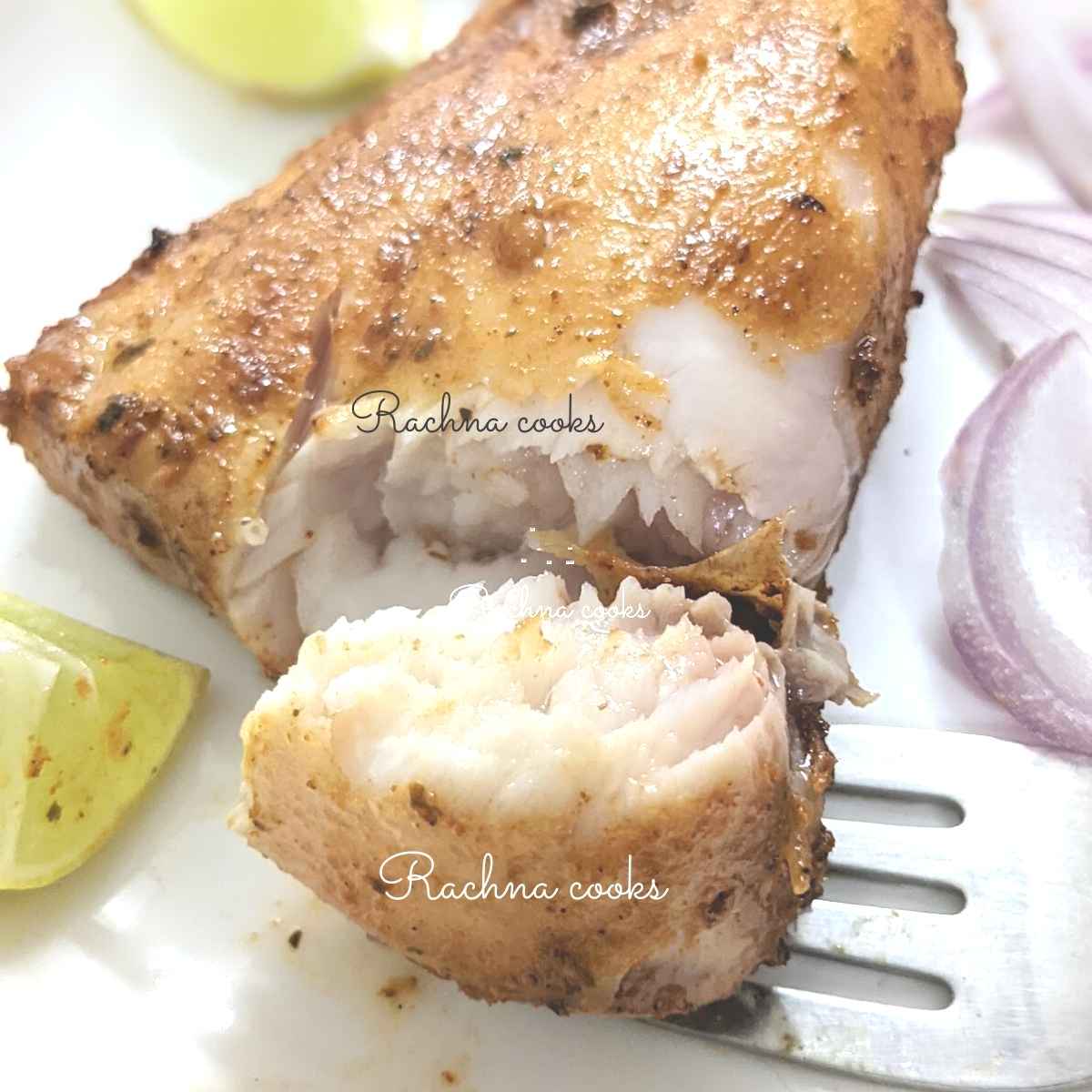 Cooked mahi mahi fillet with a piece broken off showing its flaky flesh done to perfection
