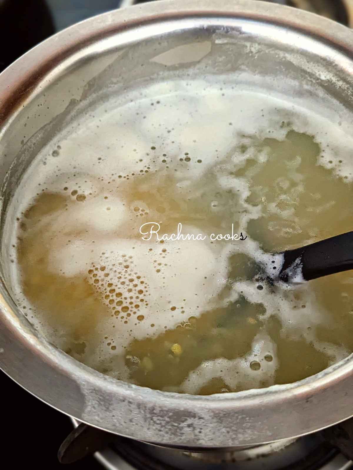 Moong dal being boiled in a pot of water.