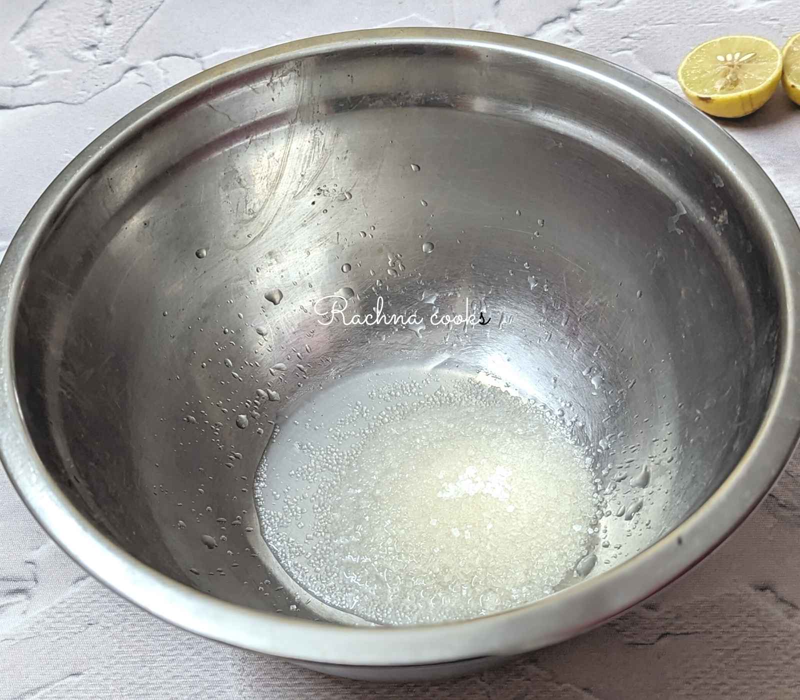 Lemon juice and sugar being mixed in a shallow bowl.