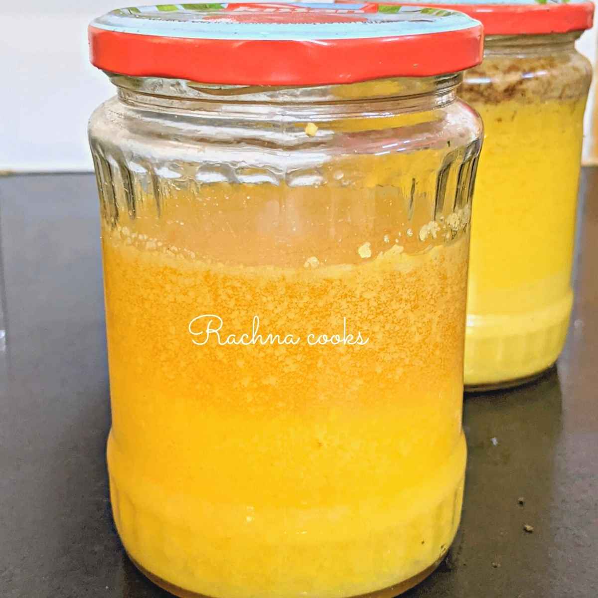 Homemade ghee in two glass bottles