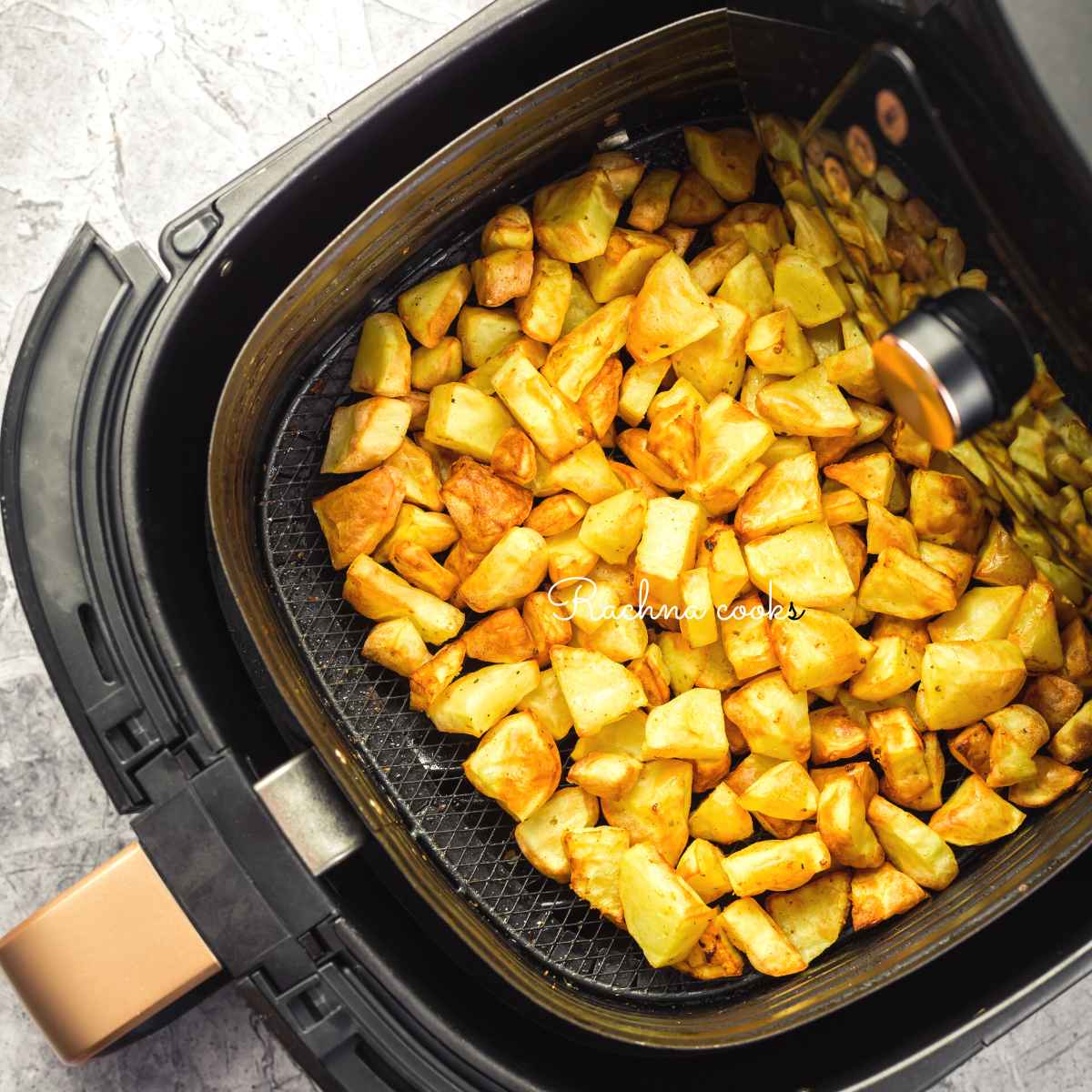 air fryer roasted potatoes in air fryer basket