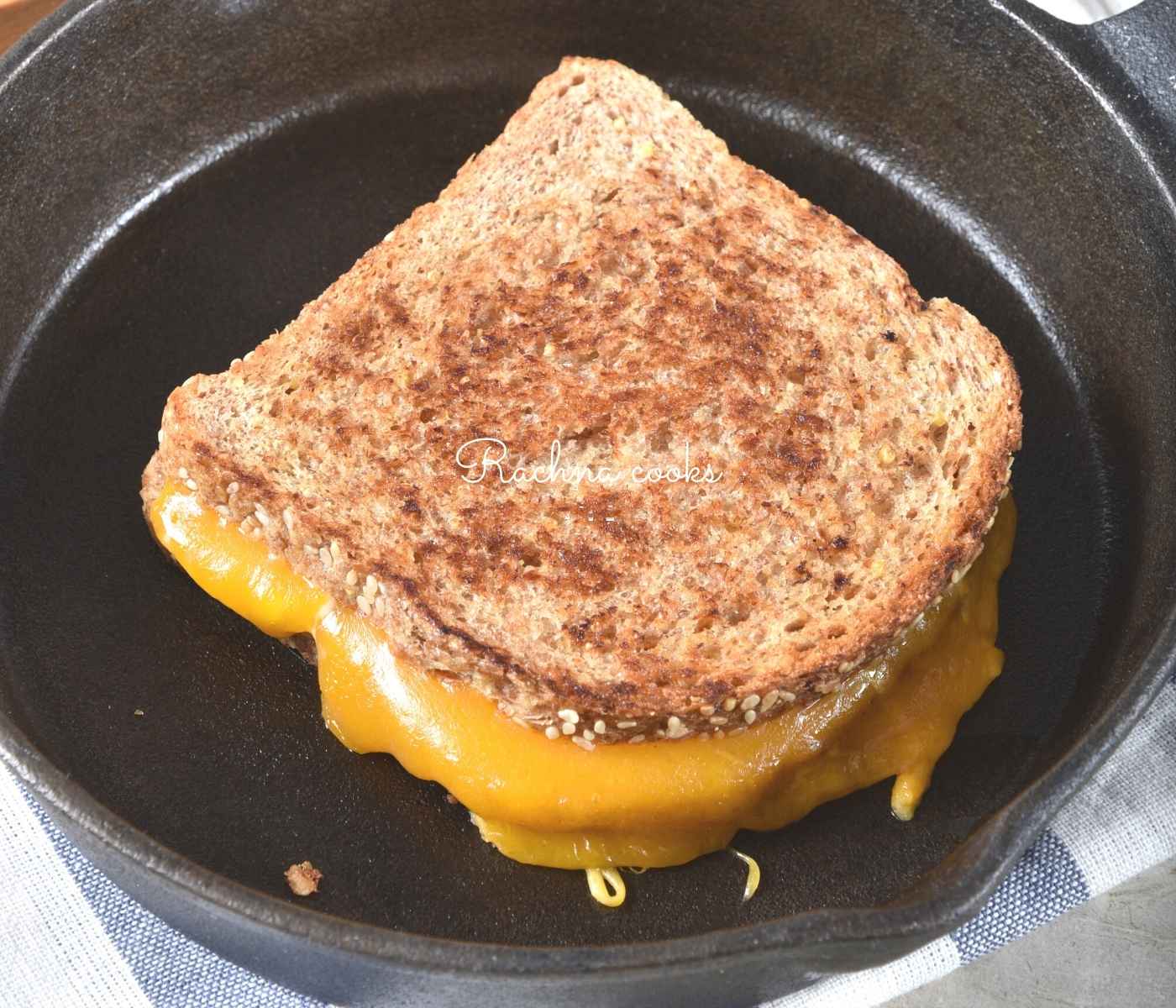 sandwich with melty cheese in a skillet