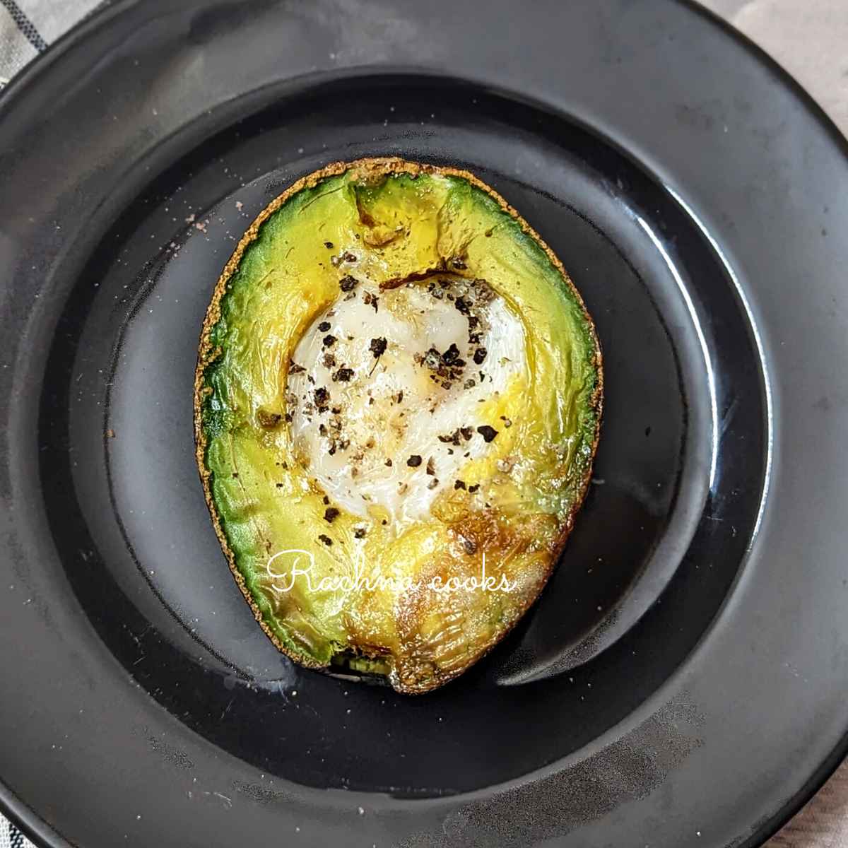 Avocado egg on a black plate