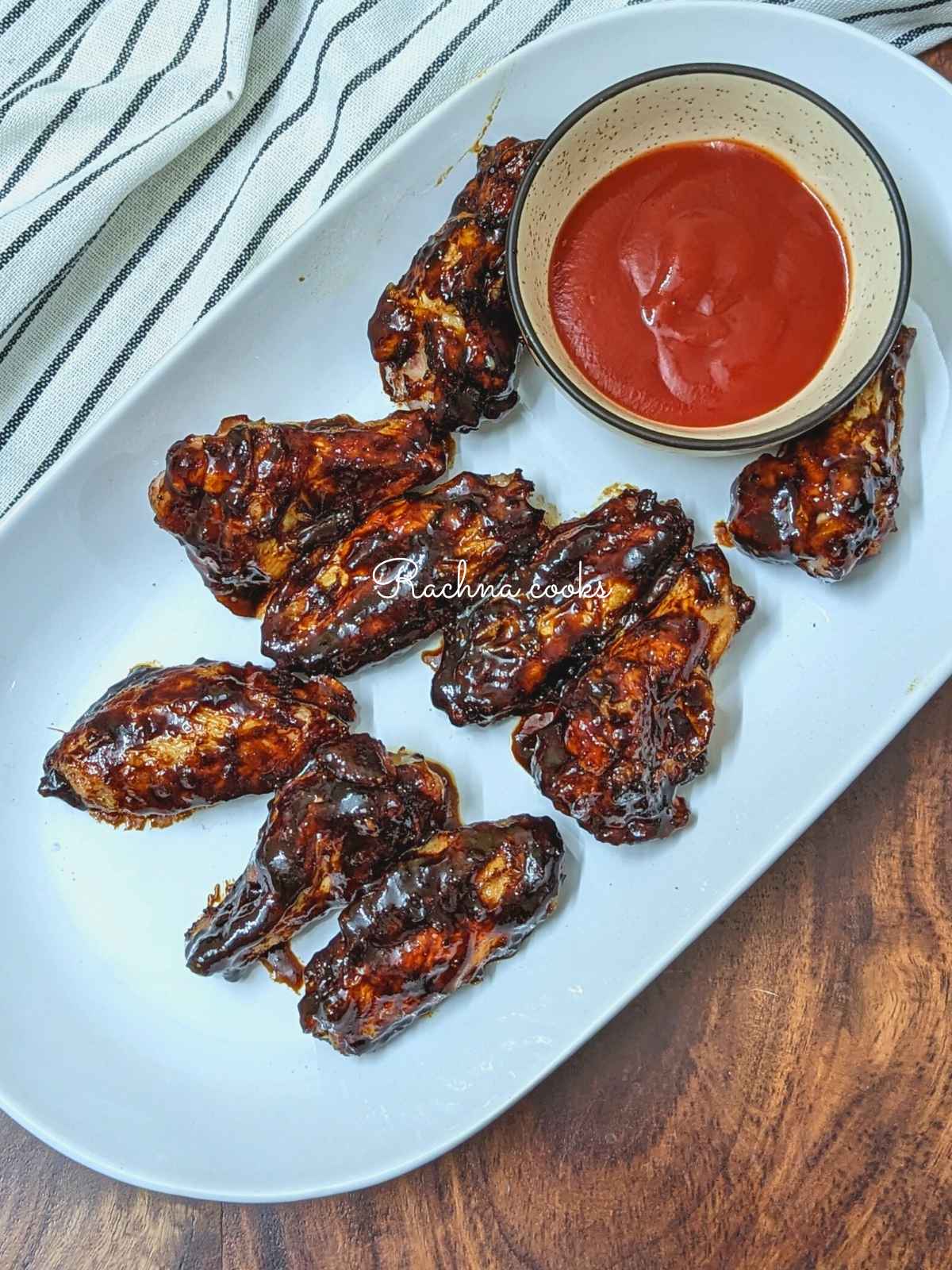 Korean chicken wings with dip served on a white platter