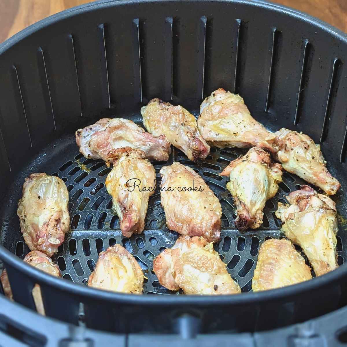 Crispy chicken wings after air frying in air fryer basket