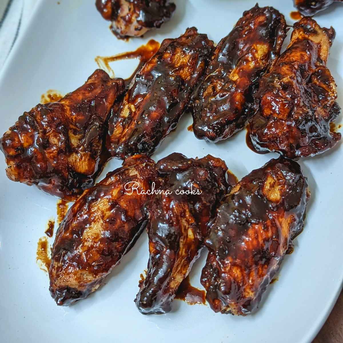 Air fried Korean chicken wings served on a white plate.