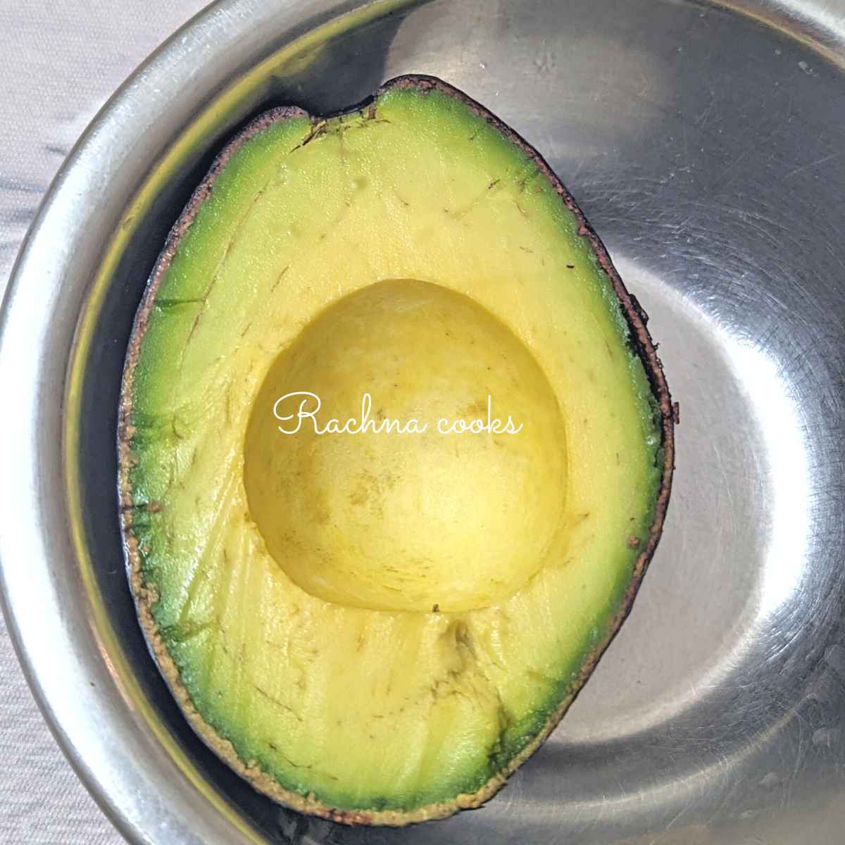 Half of an avocado after removing the pit.