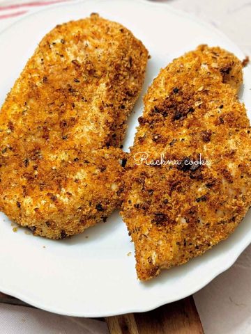 Shake and bake chicken breasts after air frying on a white plate