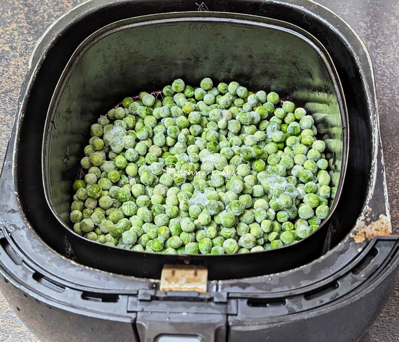 Frozen peas in an air fryer basket