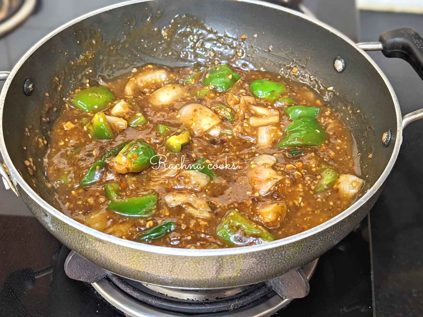 Manchurian sauce added to onion and green pepper