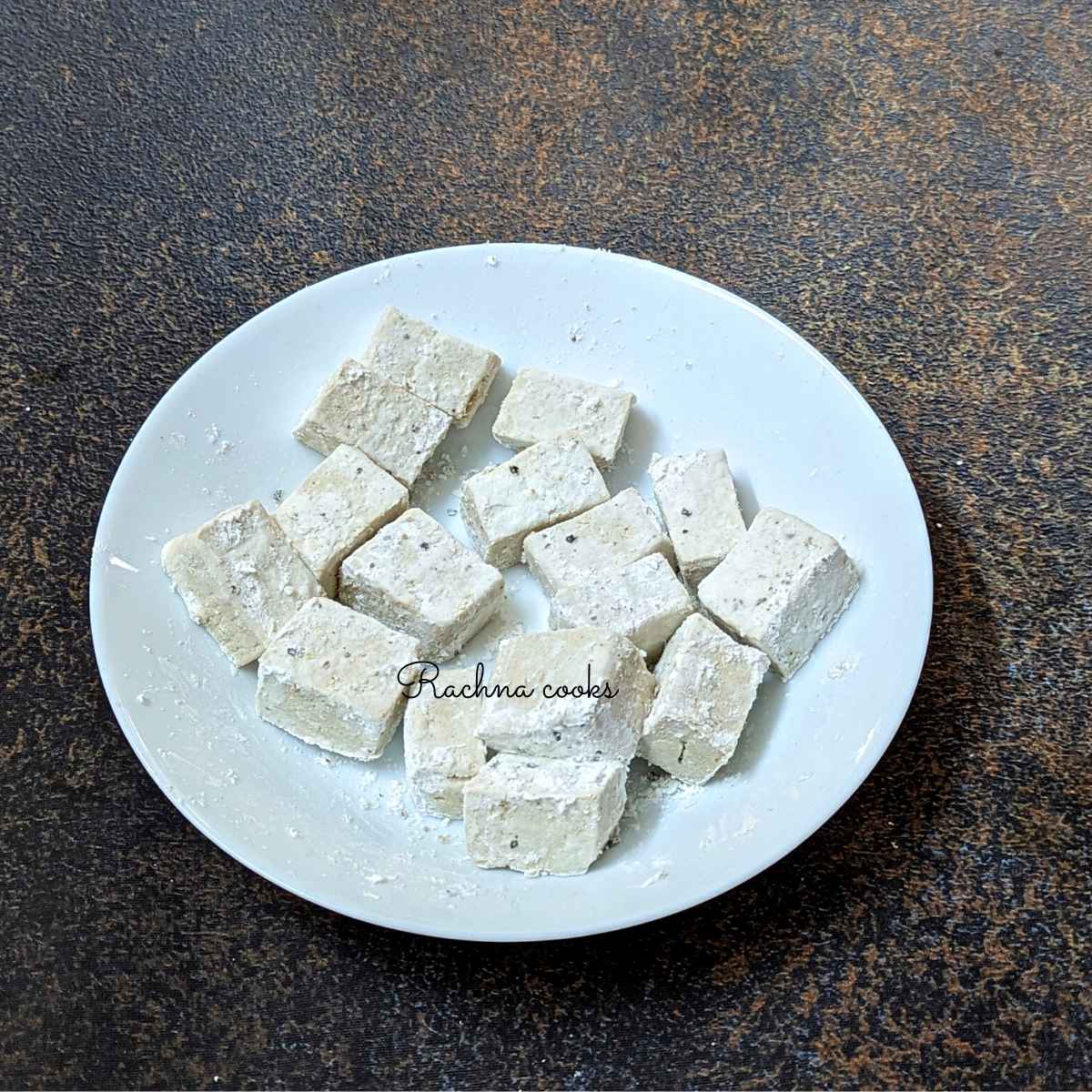 Tofu cubes coated in cornstarch, salt and pepper.