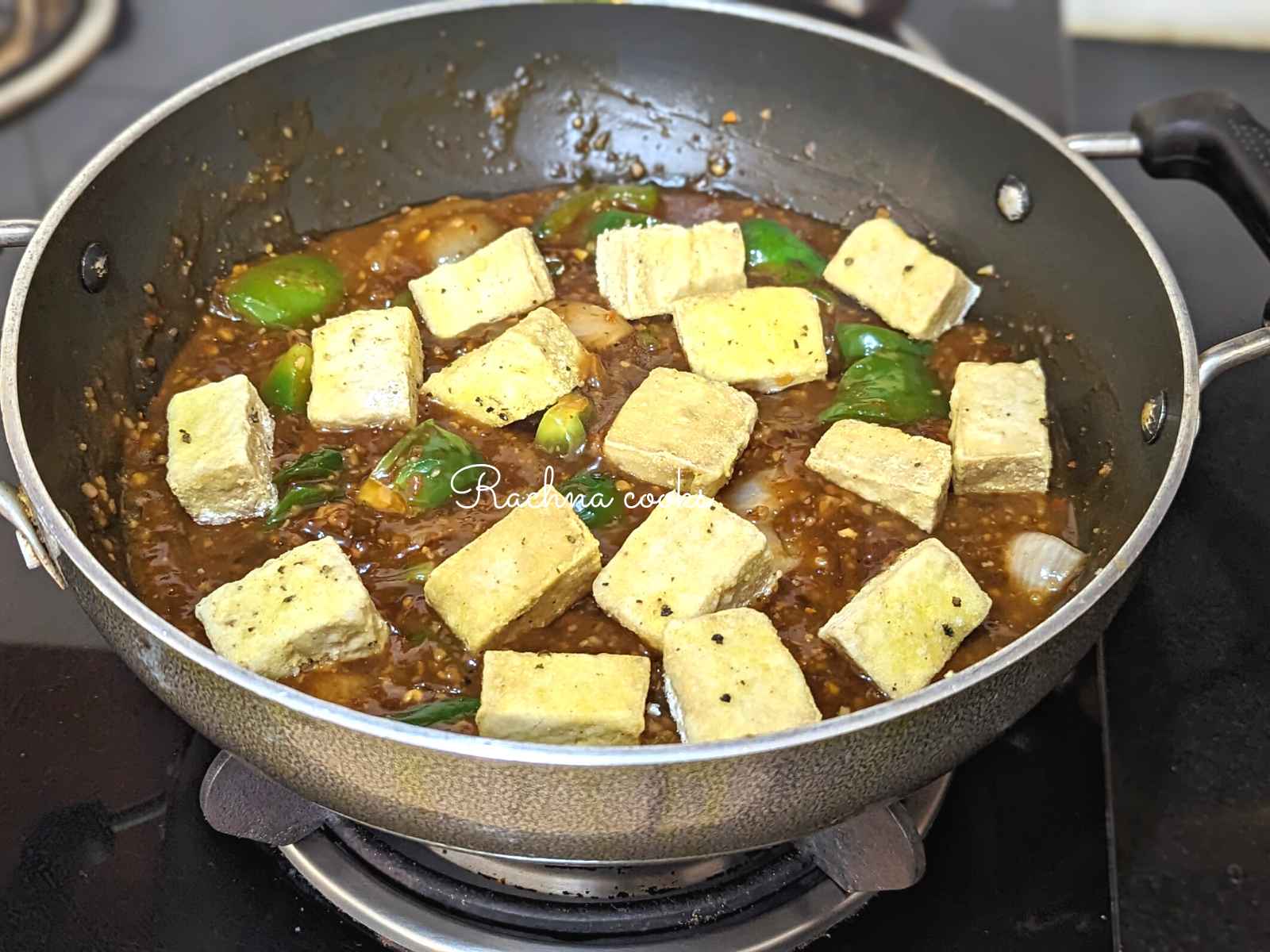 Crispy tofu added to manchurian sauce in the pan.