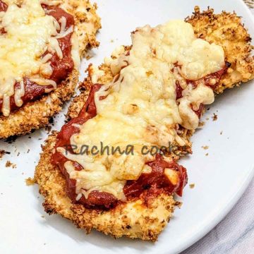 Chicken parm on a white plate.