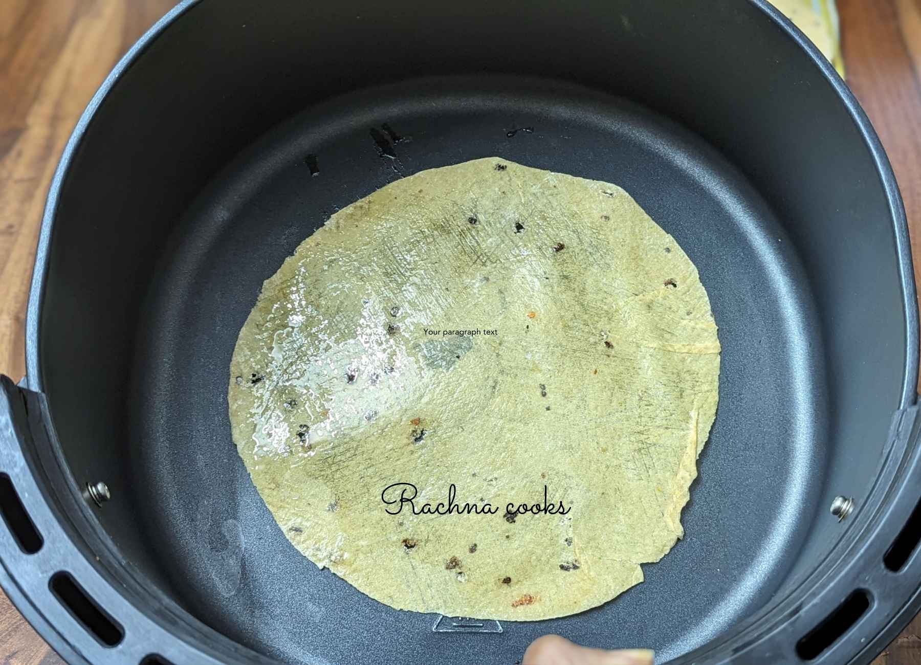 Papad with oil placed in air fryer bottom cavity.