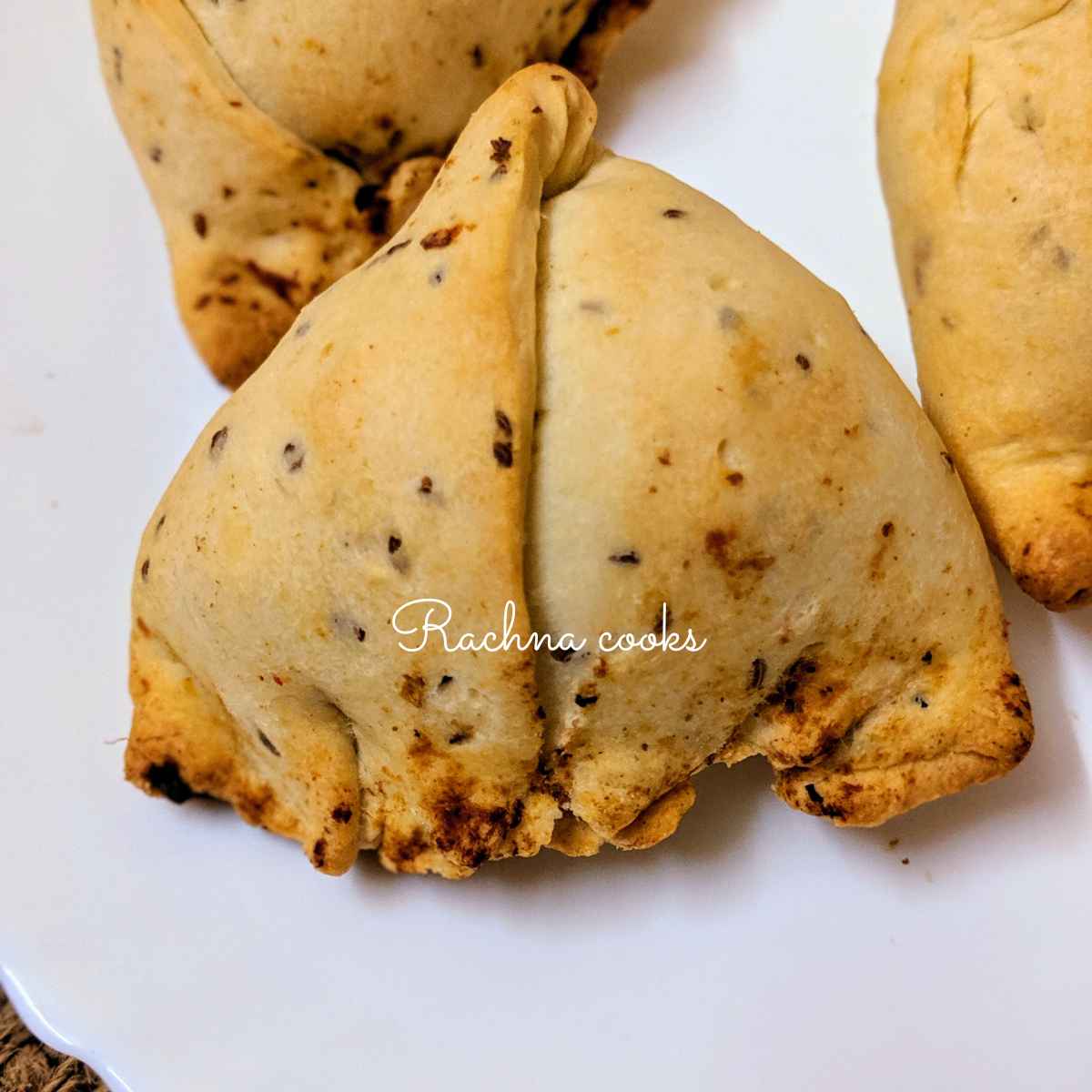 Close up of delicious air fryer samosa on a white plate.