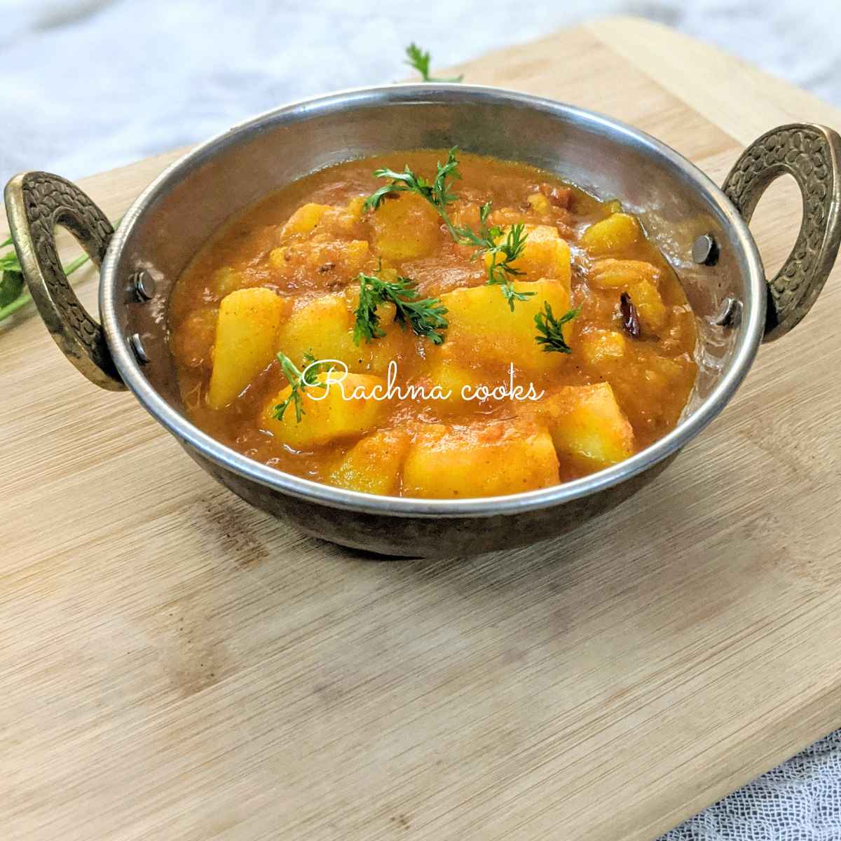 A kadhai full of aloo tamatar curry