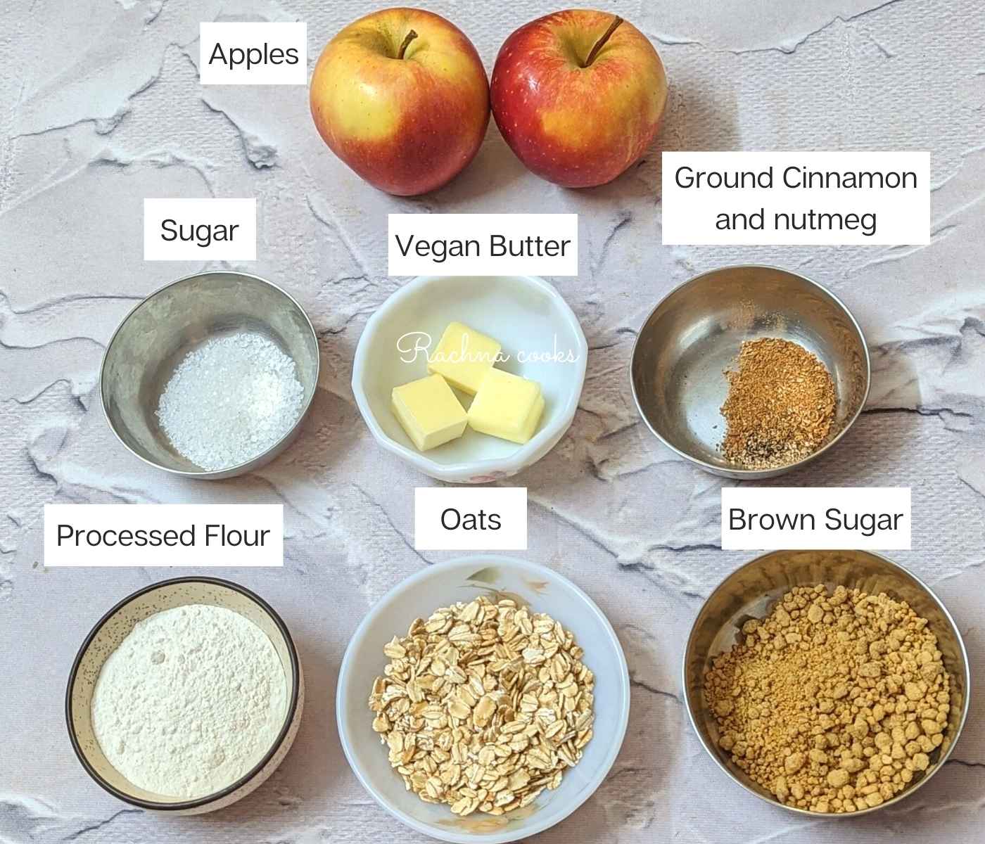 Ingredients for apple crisp: Apples, vegan butter, cinnamon and nutmeg, brown sugar, sugar, processed flour and oats