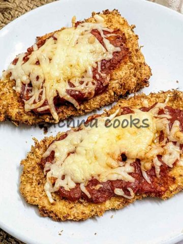 Chicken parmesan served on a white plate