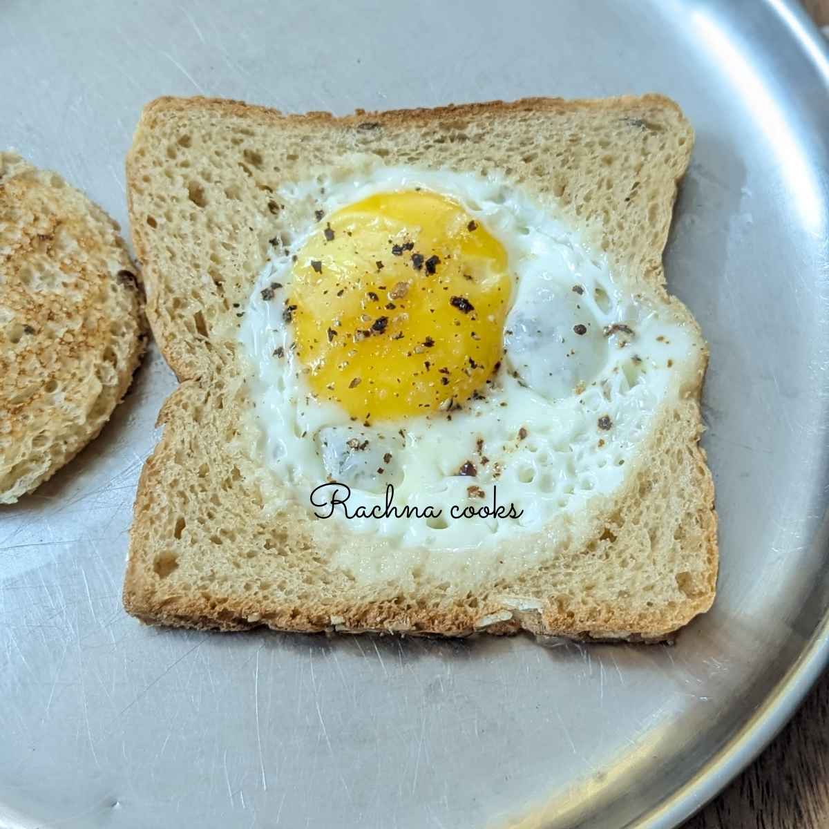 air fryer egg toast with its cavity toasted served on a plate.