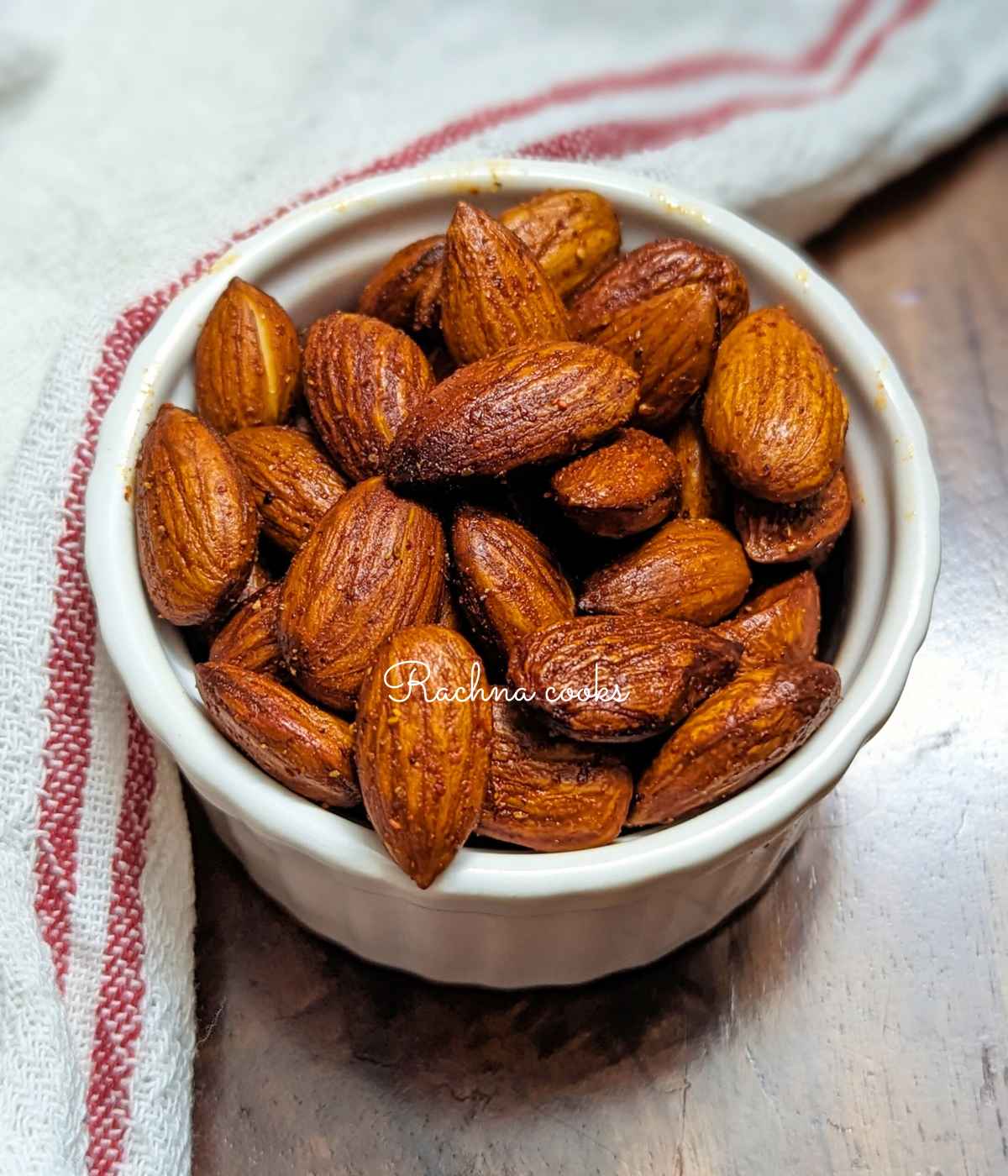 Roasted air fried peanuts served in a white bowl.