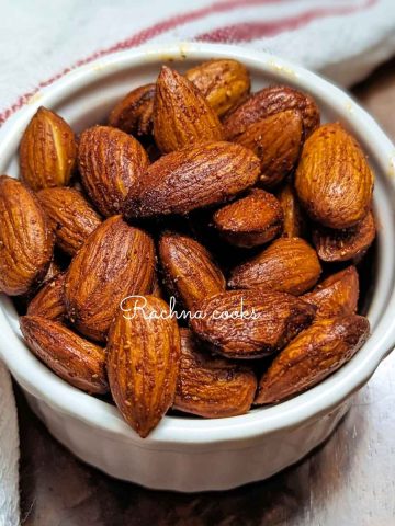 A bowl of roasted almonds tossed with seasonings.