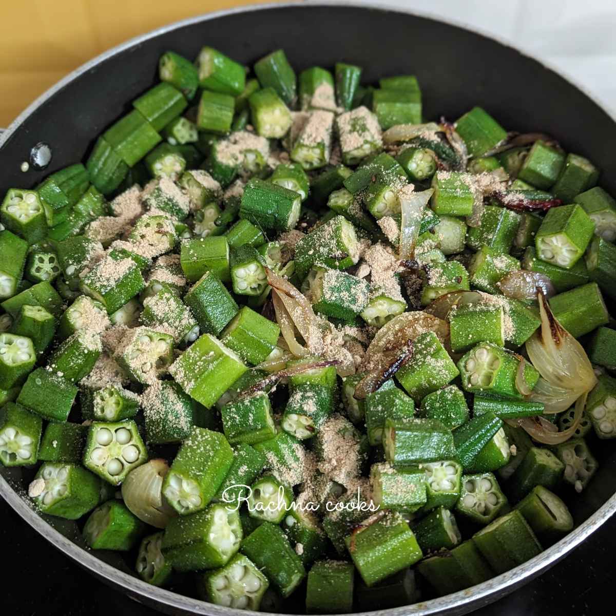 Bhhindi or okra cut into pieces mixed with the onion and amchur powder is added.