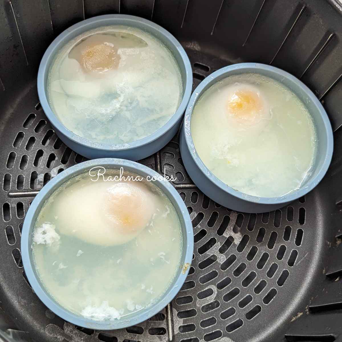 Poached eggs is silicone molds after air fryer basket.