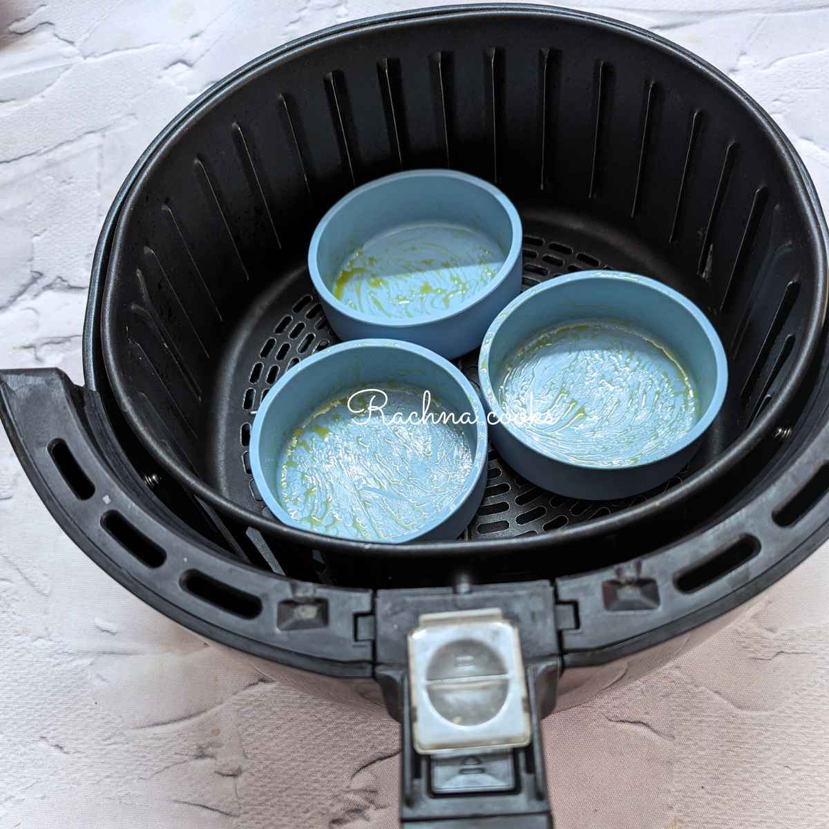 3 silicone molds placed in air fryer basket.