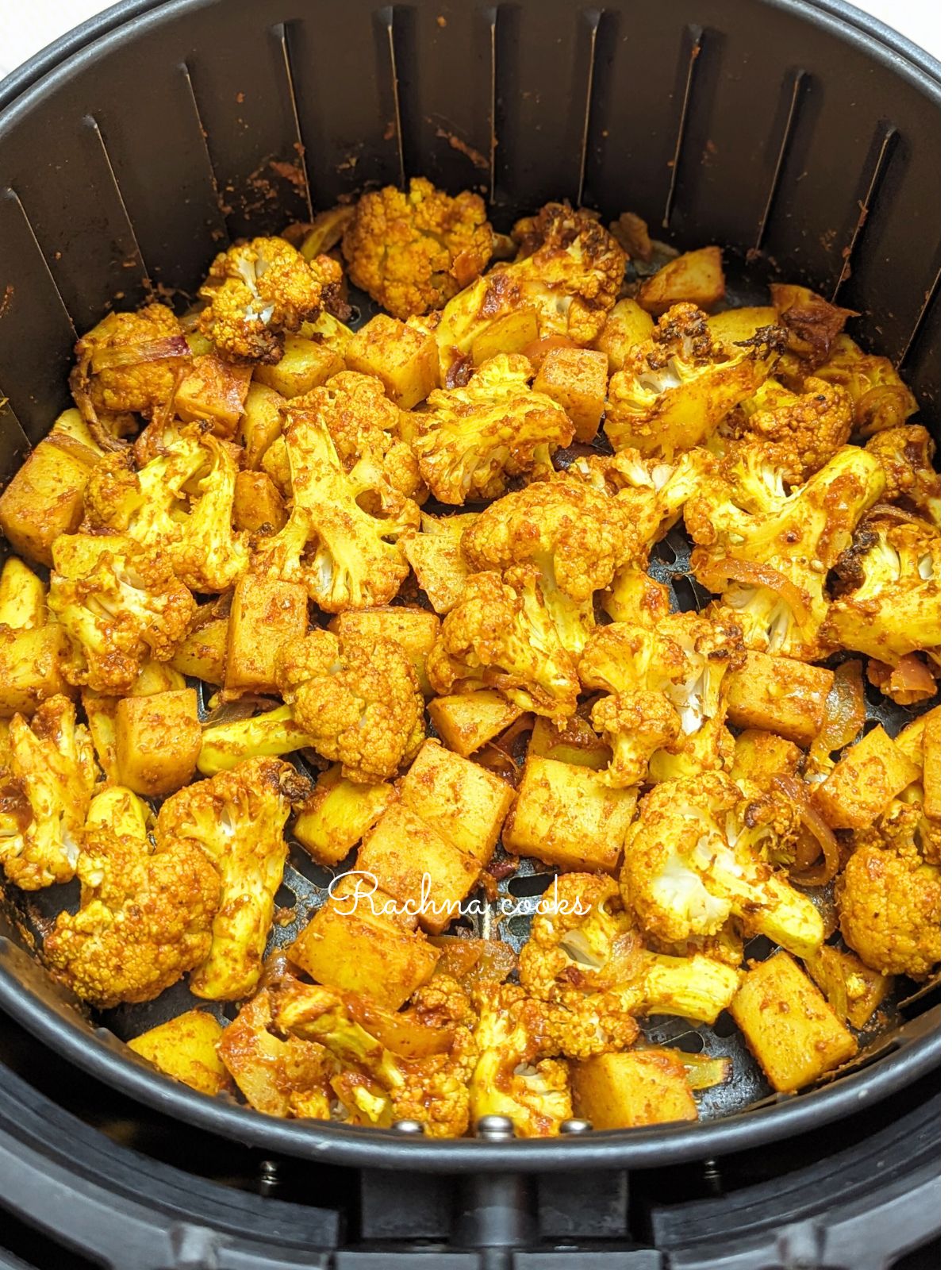 Aloo gobhi after air frying in air fryer basket.