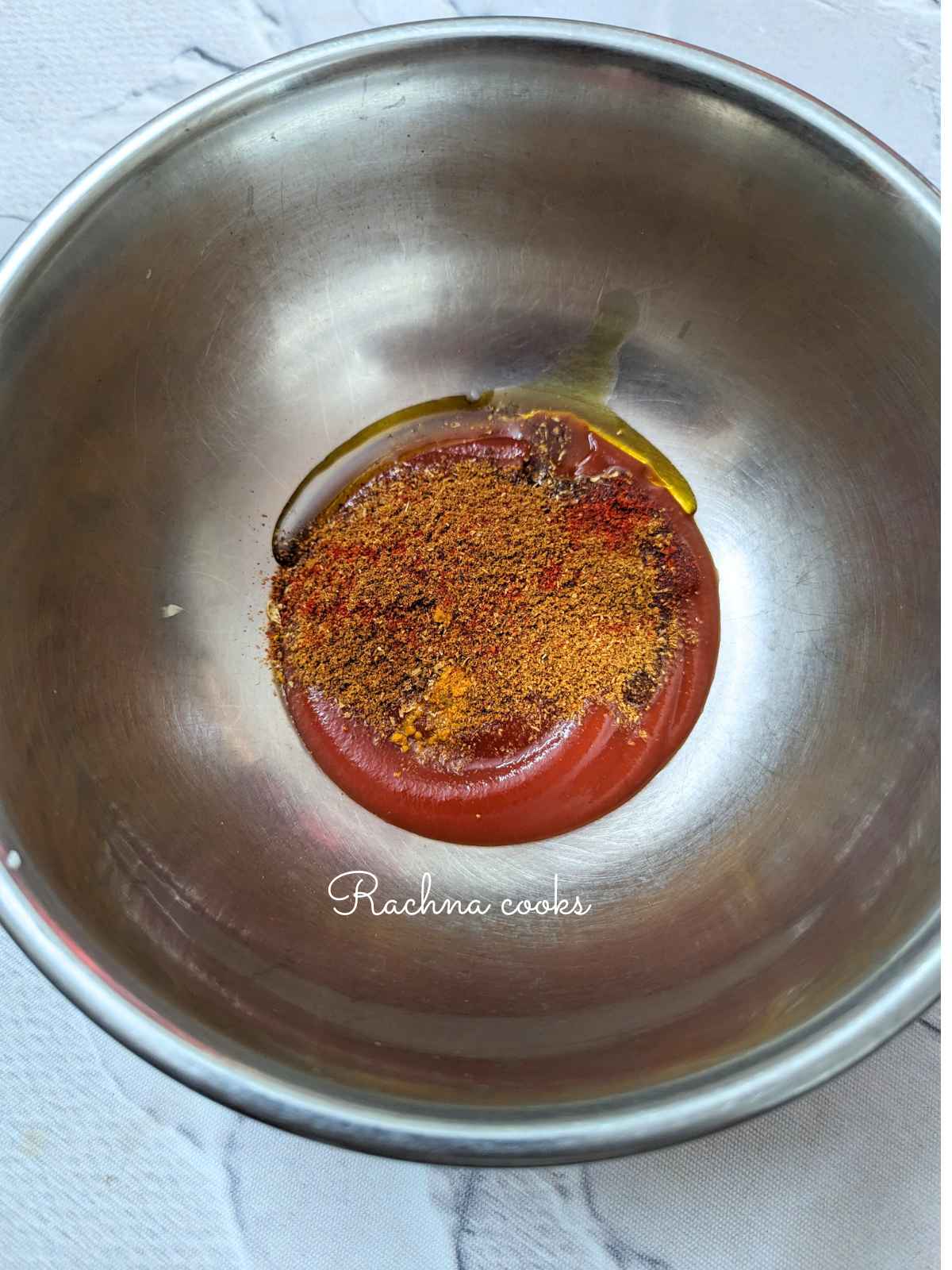 Tomato puree with spices and remaining oil