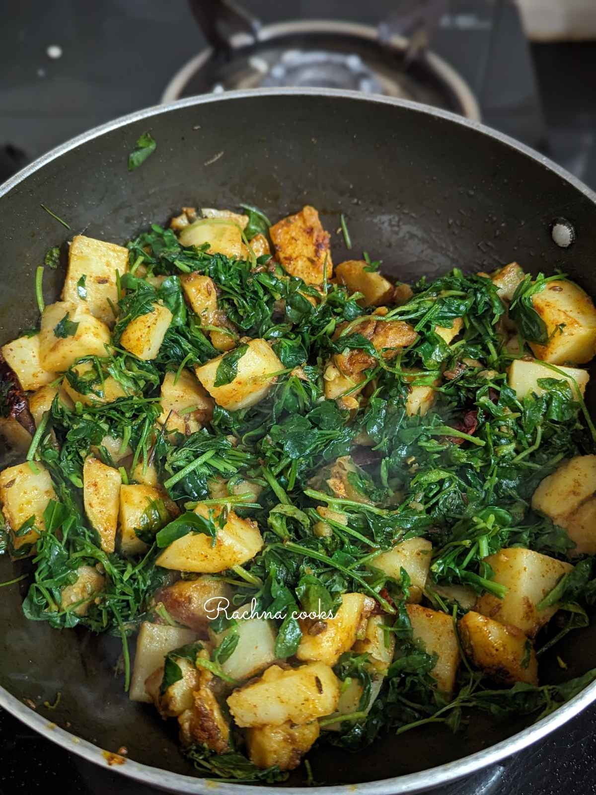 Wilted methi with potato in a kadhai