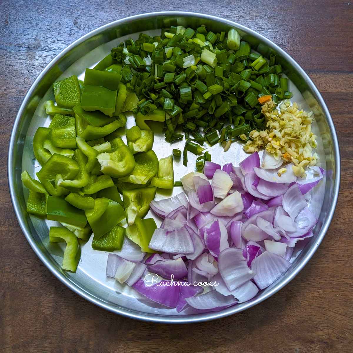 Onion, capsicum petals along with chopped spring onion, minced ginger and garlic.