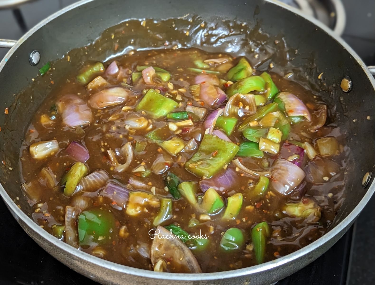 Thickened Manchurian sauce in a pan.