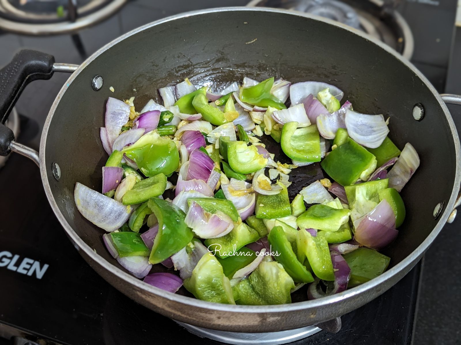 Ginger, garlic, green pepper and onion in a pan.