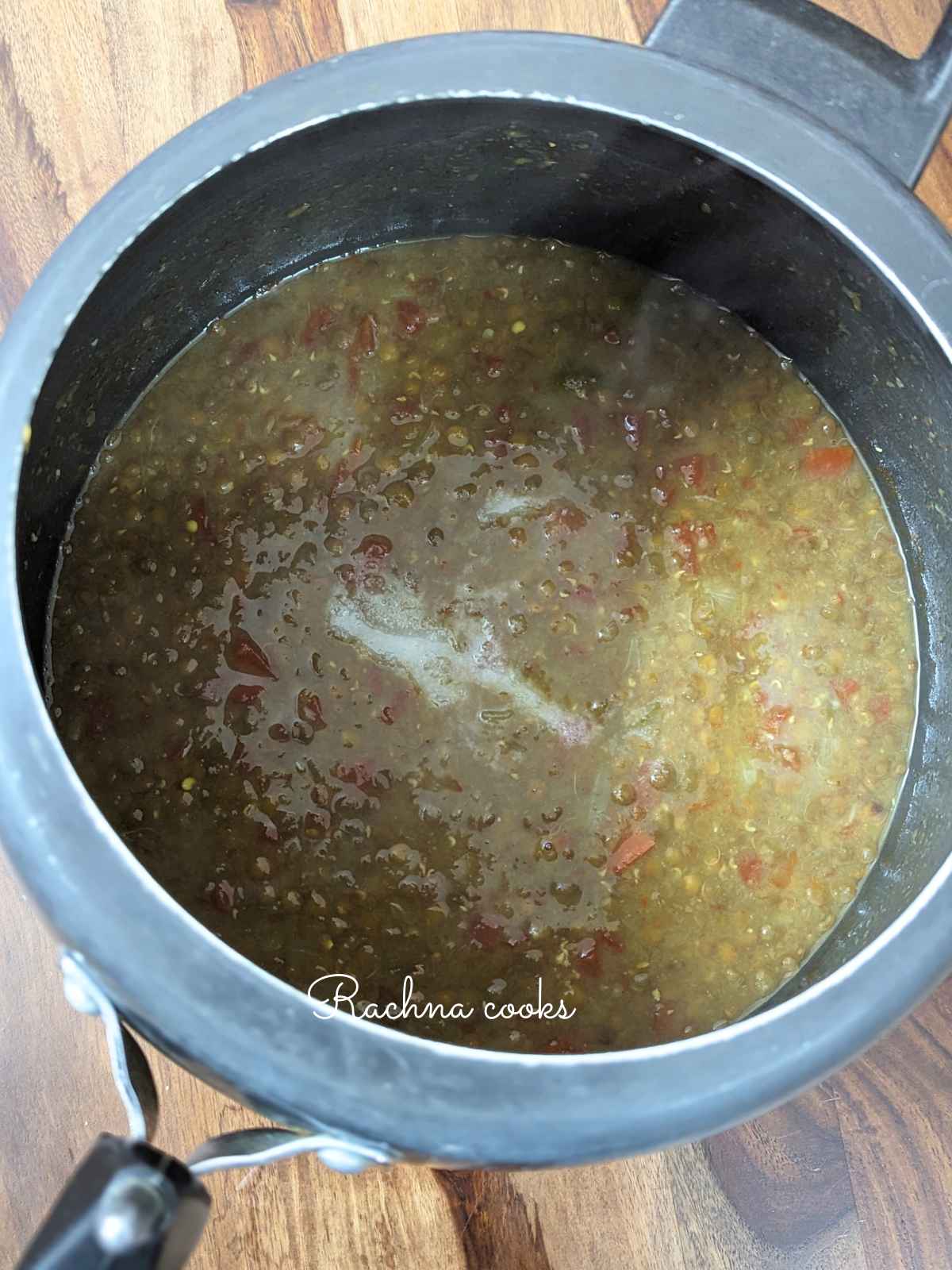 Masoor dal with added water, salt and spices in pressure cooker.