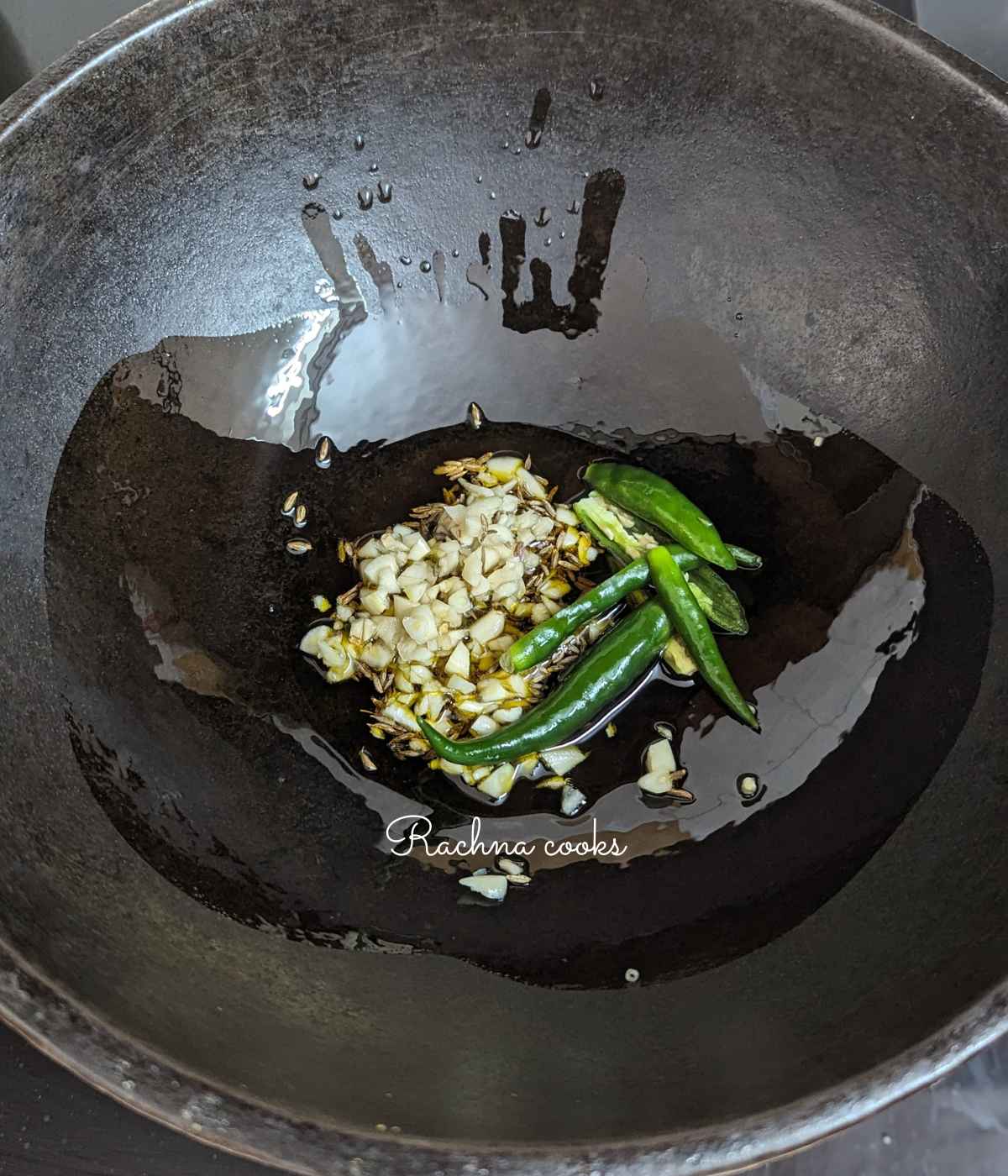 cumin, garlic and chillies in oil in a kadhai