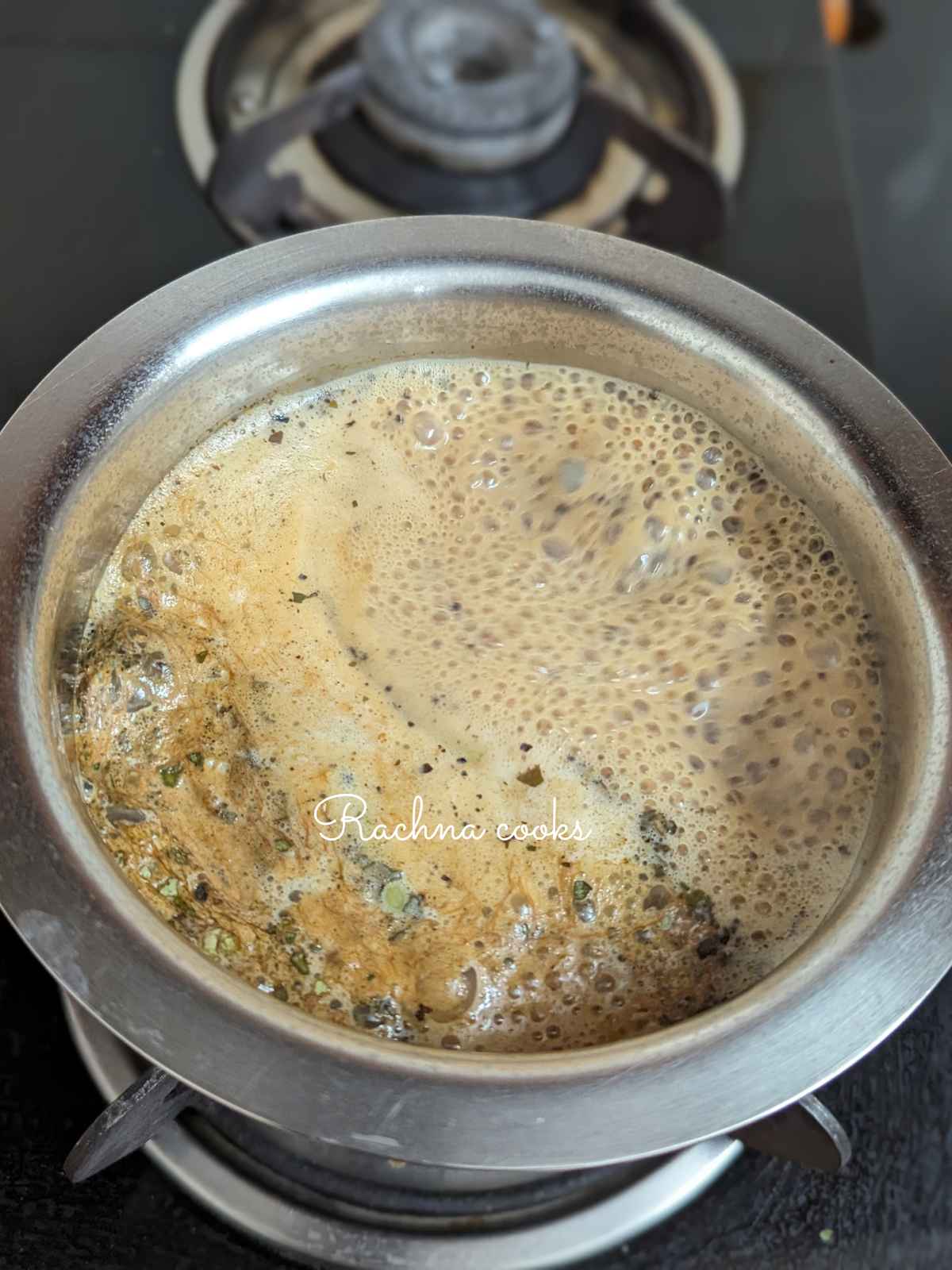 Boiling lemongrass tea after adding milk to it.