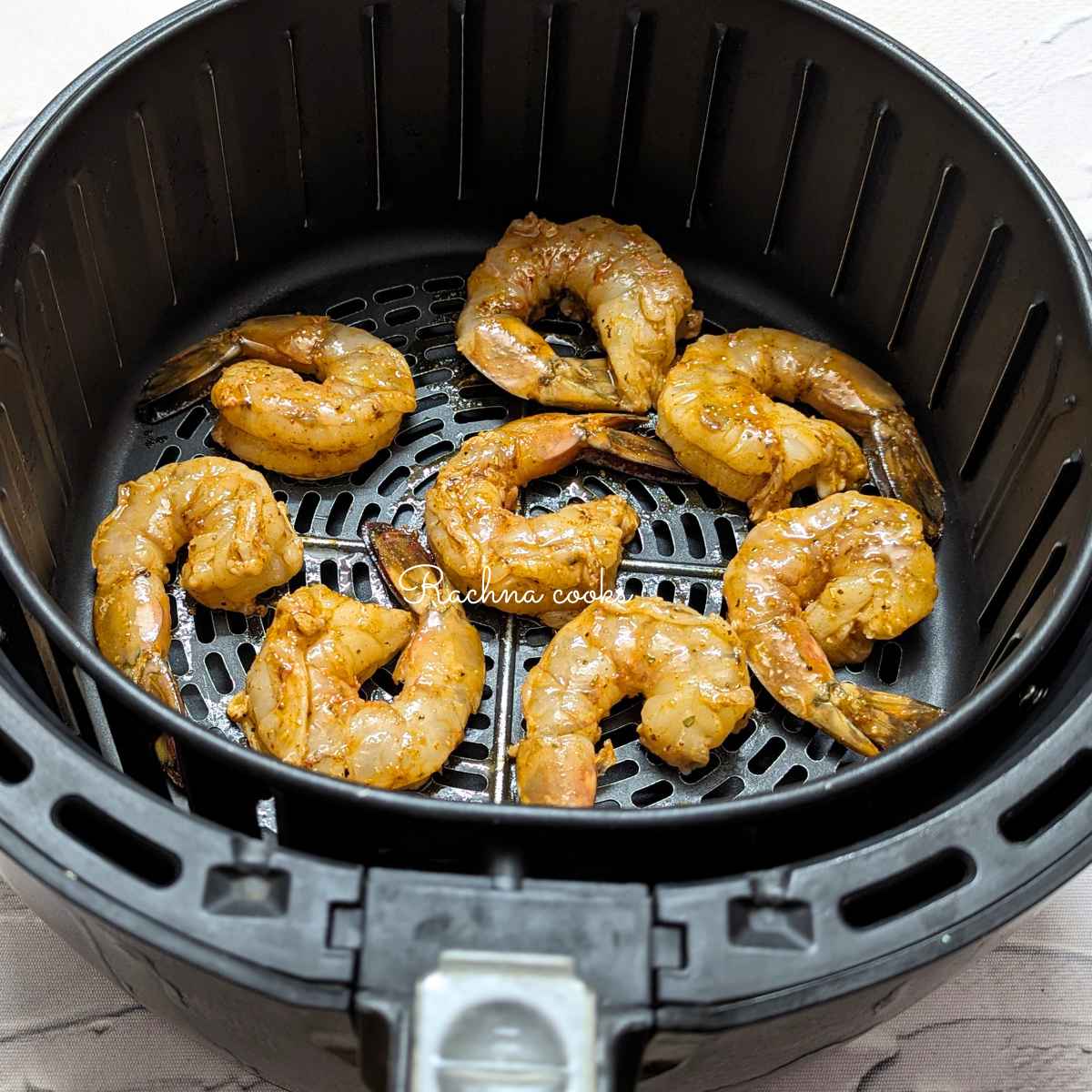 Seasoned shrimp placed in air fryer basket