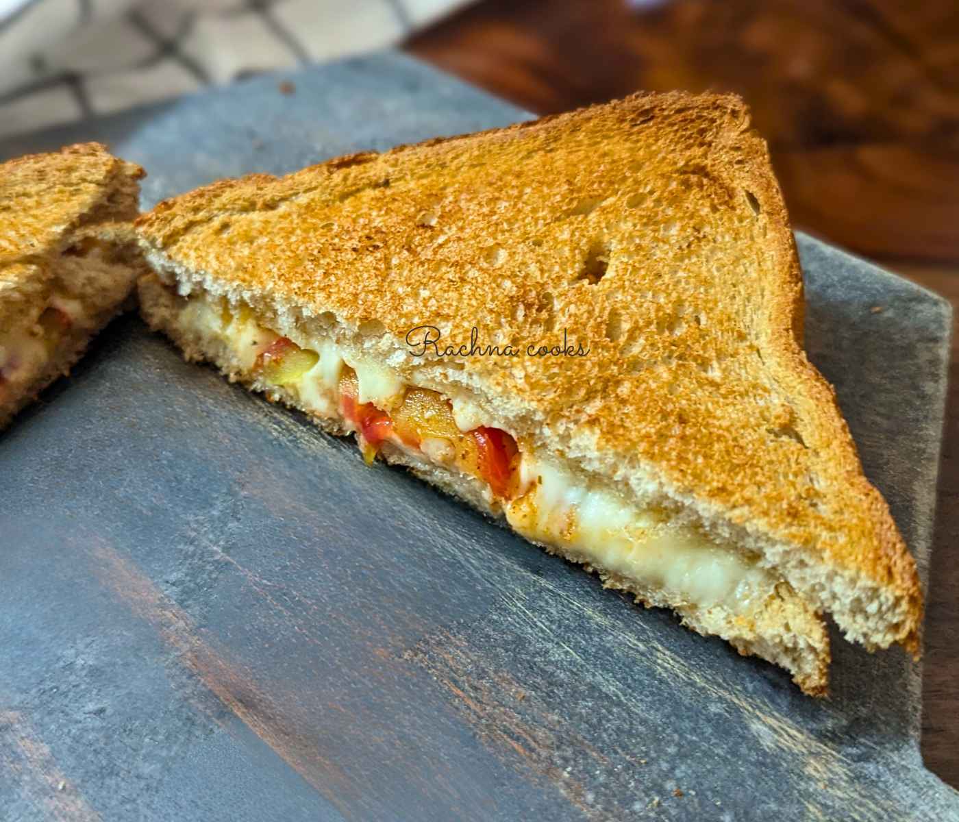 Melty tomato melt cheese sandwich half.