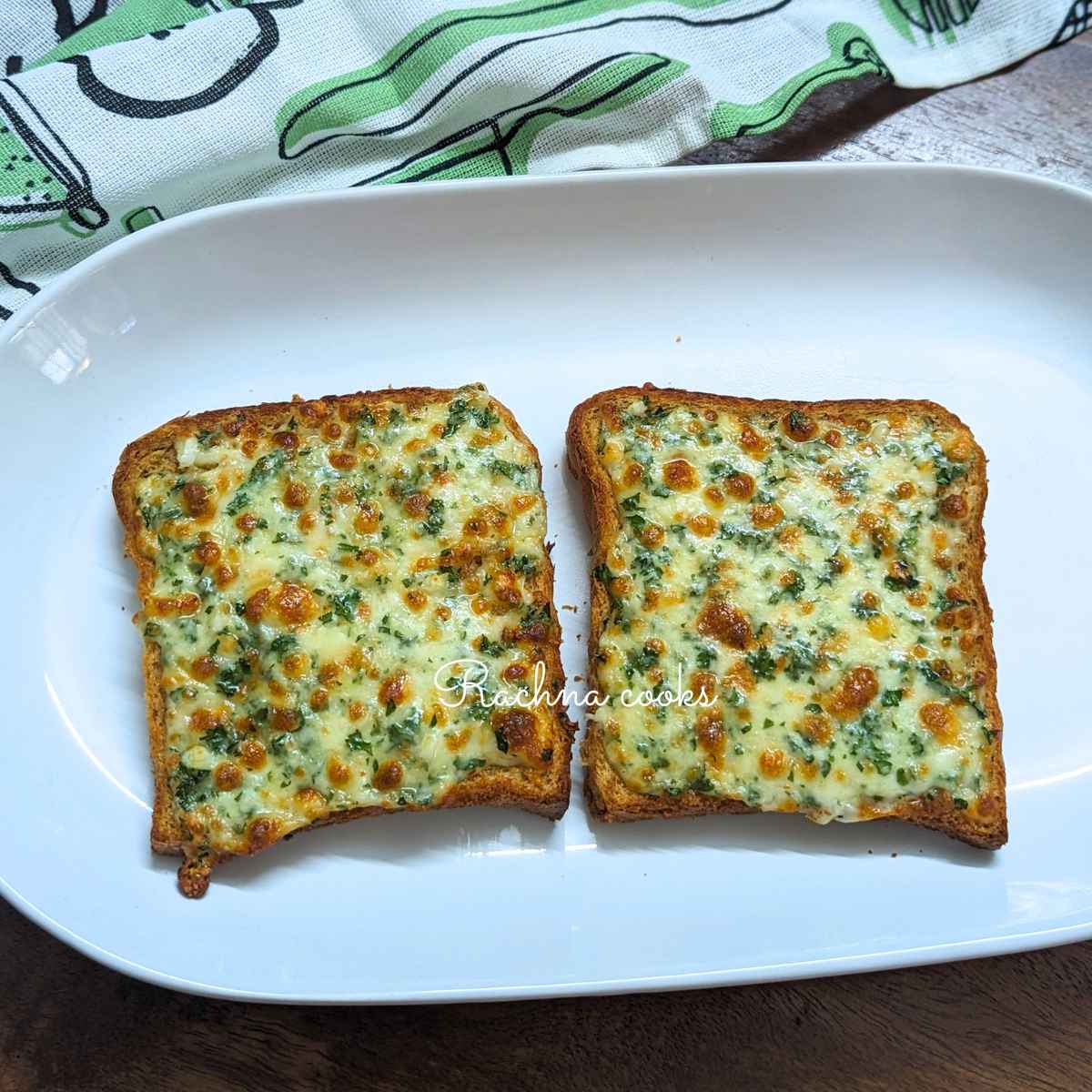 2 slices of browned garlic bread served on plate.