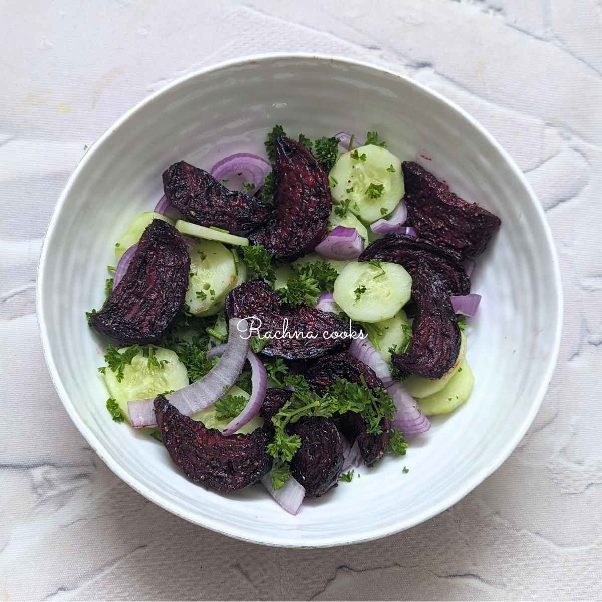 Beets, cucumber, onion and parsley in a bowl