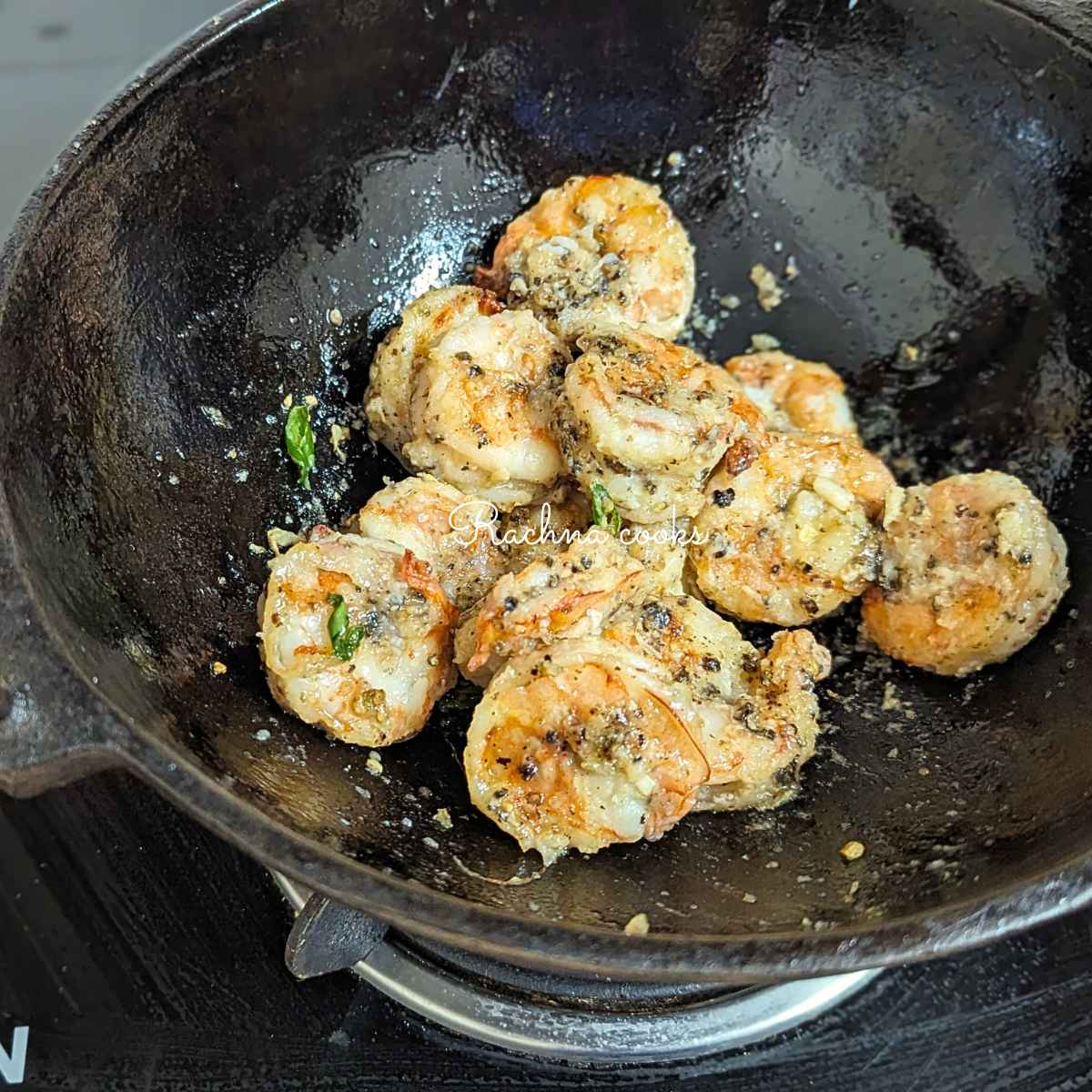 Salt and pepper shrimp after tossing in garlic and chilli oil
