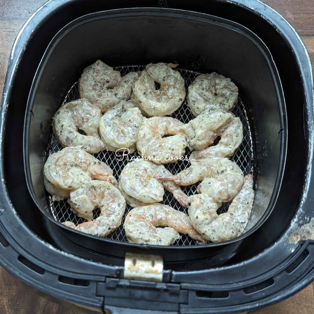 Coated shrimp placed in air fryer basket
