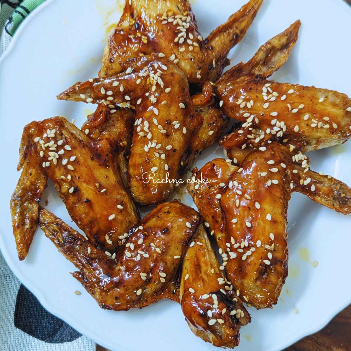 Delicious teriyaki wings after air frying served on a white plate.